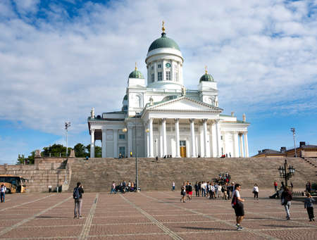 tourists on senate square in front of helsinki cathedral on sunny summer day with blue sky and white cloudsのeditorial素材