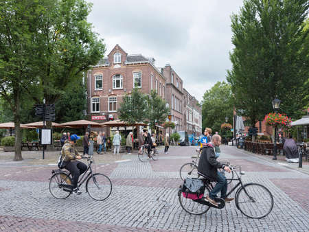 people on bicycle on ledig erf in old medieval city of utrecht in the netherlandsのeditorial素材