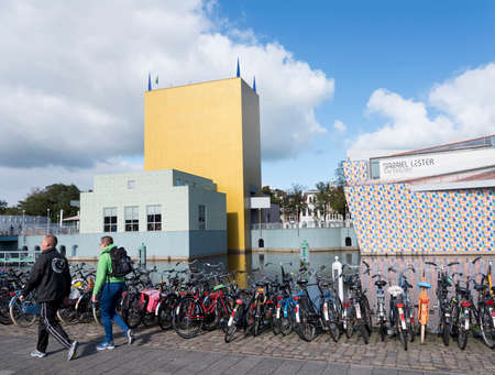 bicycles and yellow tower of groninger museum in dutch town of groningen in the netherlandsのeditorial素材