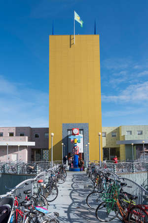 bicycles and yellow tower of groninger museum in dutch town of groningen in the netherlandsのeditorial素材