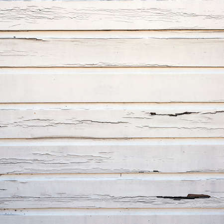 peeling white paint on horizontal wooden planks of shed wallの写真素材