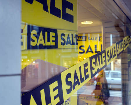 the word sale oin colorful display in shopping window during winter sale timeの写真素材