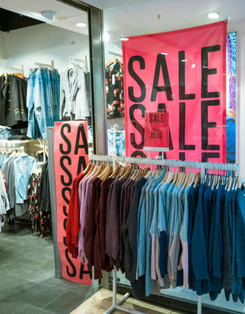 Big letters indicate sale in shop windows of clothing storeの写真素材