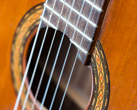 closeup of hole in spanish classical guitar and snaresの写真素材