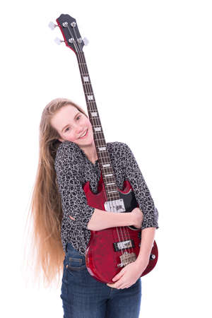 blond pretty teen girl and red bass guitar against white background in studioの写真素材