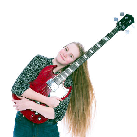 blond pretty teen girl and red bass guitar against white background in studioの写真素材