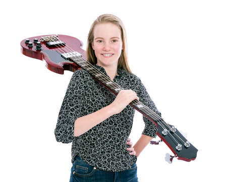 blond pretty teen girl and red bass guitar against white background in studioの写真素材