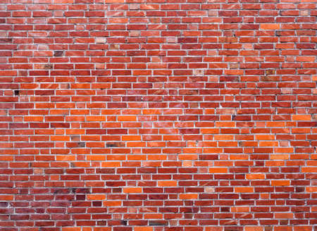 part of wall masonry with bright red old bricksの写真素材