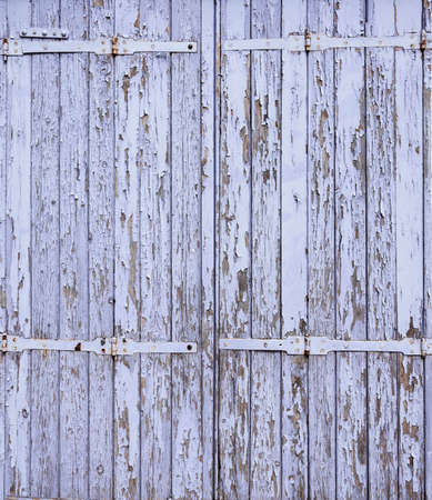 background consisting of peeling blue purple paint on old doorの写真素材
