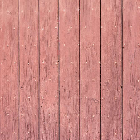 background consisting of reddish brown peeling paint on wooden shuttersの写真素材