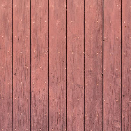 background consisting of reddish brown peeling paint on wooden shuttersの写真素材