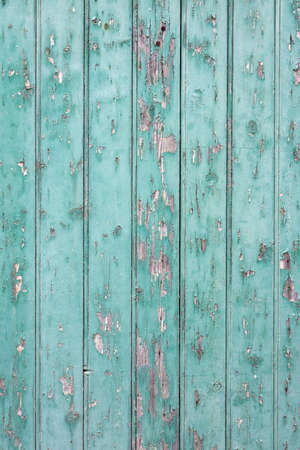 background consisting of old blue green door with peeling paintの写真素材
