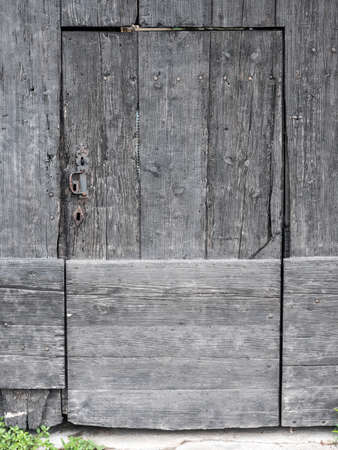 very old grungy dark brown door larger wooden door in french provenceの写真素材