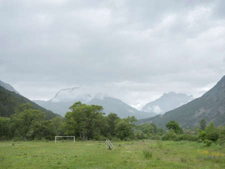 foorball field with goals in valley between mountains of french haute provence