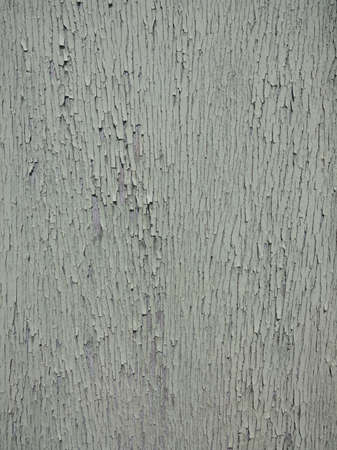 closeup of cracked peeling green paint forming almost abstract backgroundの写真素材