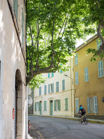 bargemon, france, 13 june 2018: cyclist enters the old medieval french provence town of bargemonのeditorial素材