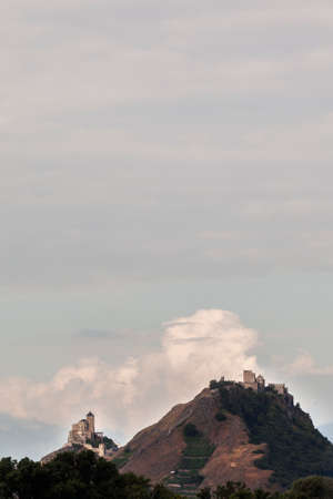 castle and church on hill above swiss town of sion in the rhone valley in wallis or valaisの写真素材
