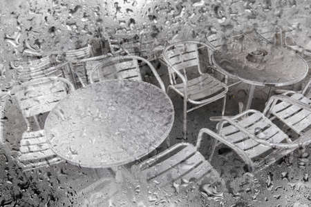 rainy day on empty terrace with metal furniture in Amsterdamの写真素材