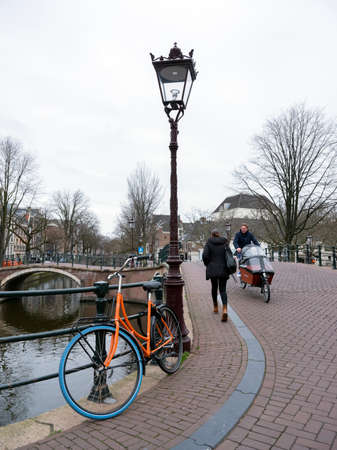 amsterdam, netherlands, 10 january 2010: bicycles and bridges on corner of prinsengracht and reguliersgracht in amsterdam centre on overcast winter dayのeditorial素材