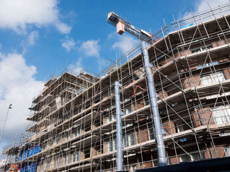 scaffolding around construction site of large building in dutch town of utrechtの写真素材