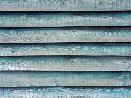 part of green wall on wooden barn or fence with horizontal planksの写真素材