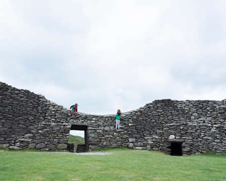 Kerry, Ireland, 26 july 2019: tourists on staigue stone fort on kerry peninsula in irelandのeditorial素材