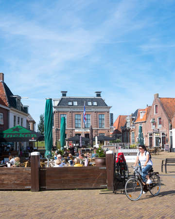 Makkum, Netherlands, 23 august 2019: people enjoy nice weather on open air cafe in village of makkum in dutch province of Frieslandのeditorial素材