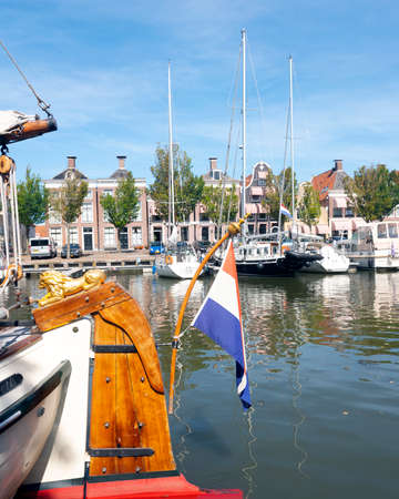 old sailing vessels in harbor noorderhaven of harlingen in dutch province of friesland on sunny dayのeditorial素材