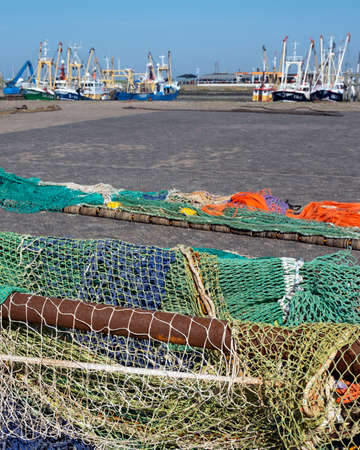 fishing nets dry in the sun in harbor of lauwersoog in the dutch province of groningenの写真素材