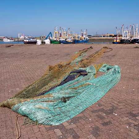 fishing nets dry in the sun in harbor of lauwersoog in the dutch province of groningenの写真素材