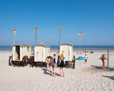 norderney, germany, 25 august 2019: old fashioned bathing carts used for changing on sunny beach of german island norderney under blue summer skyのeditorial素材