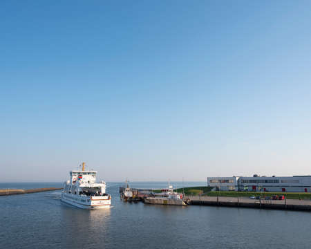 norddeich, 25 august 2019: ferry from island opf norderney arrives in harbor of norddeich on sunny...
