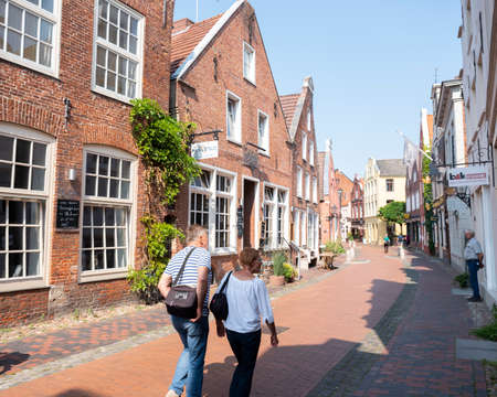 Leer, Germany, 26 august 2019: older couple enters beautiful old street in centre of leer in lower...