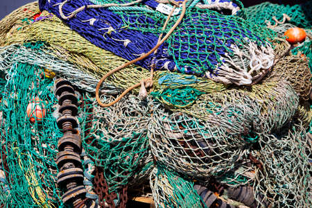 closeup of colorful fishing nets in harbor form an almost abstract pattern