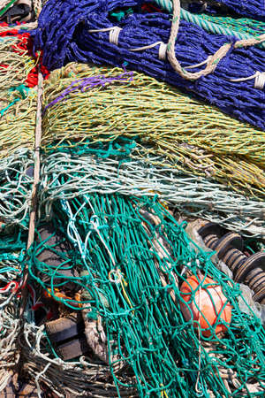 closeup of colorful fishing nets in harbor form an almost abstract pattern