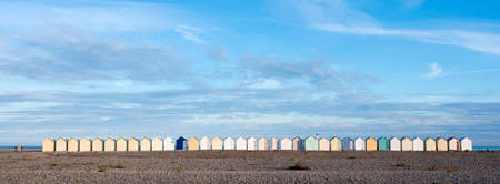 beach huts in cayeux s mer in french normandy under blue skyの写真素材
