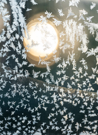 pattern of frost flowers on windscreen of carの写真素材