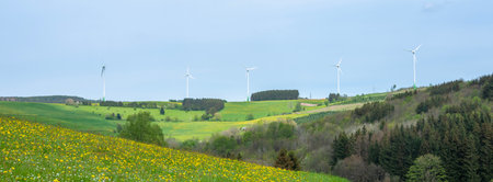 colorful German Sauerland landscape in spring with wind turbines under blue skyの写真素材