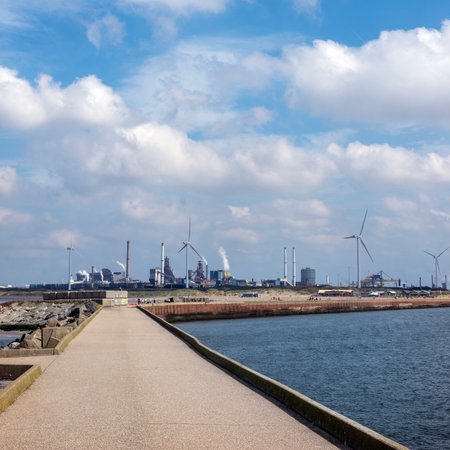 smoking chimneys of tata steel factory in the netherlands seen from north pier of north sea canalの写真素材