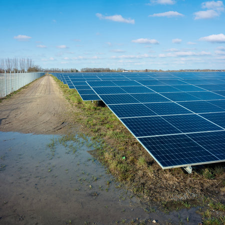 solar panel field under blue sky with fluffy clouds in dutch area near utrecht in the netherlandsの写真素材