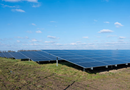 solar panel field under blue sky with fluffy clouds in dutch area near utrecht in the netherlandsの写真素材