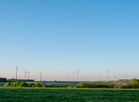 German countryside with wind turbines under blue sky in Saarland in spring