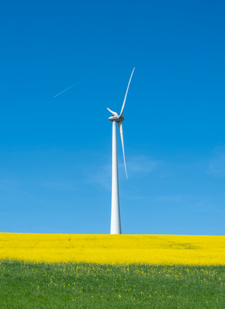 agricultural countryside landscape in luxembourg with wind turbine under blue sky in springの写真素材