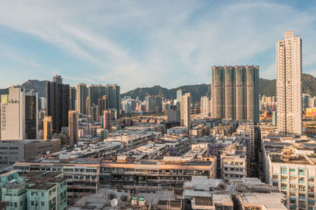 Aerial angle of Colorful messy rooftop on dense old residential house in Kowloon, Hong Kong, evening.のeditorial素材