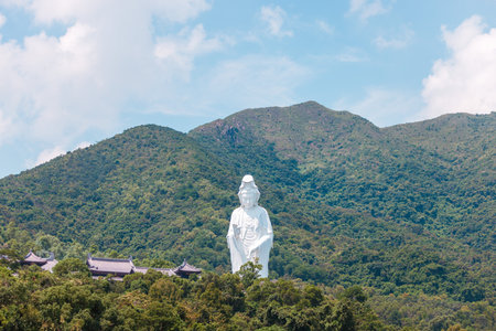 Giant Guanyin, Goddess Statue in countryside landscape of Tai Po, Hong Kong, daytime, clear dayの写真素材
