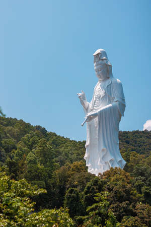 Giant Guanyin, Goddess Statue in countryside landscape of Tai Po, Hong Kong, daytime, clear dayの写真素材