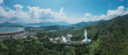 Giant Guanyin, Goddess Statue in countryside landscape of Tai Po, Hong Kong, daytime, clear dayの写真素材