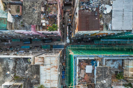 Amazing top view of messy rooftop of old residence building in Kowloon district, Hong Kong. Drone shot in daytimeの写真素材