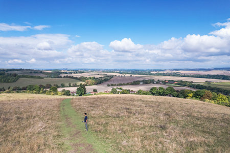 Hiking man walking in the field, Amazing view of Goring and Streatley, village town near Reading, England.の写真素材