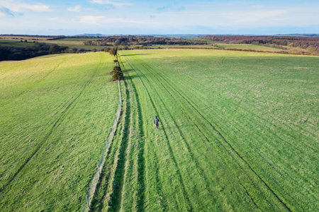 beautiful countryside in Pewsey, Wiltshire. Backpacker walking in footpath outdoor, spring daytimeの写真素材